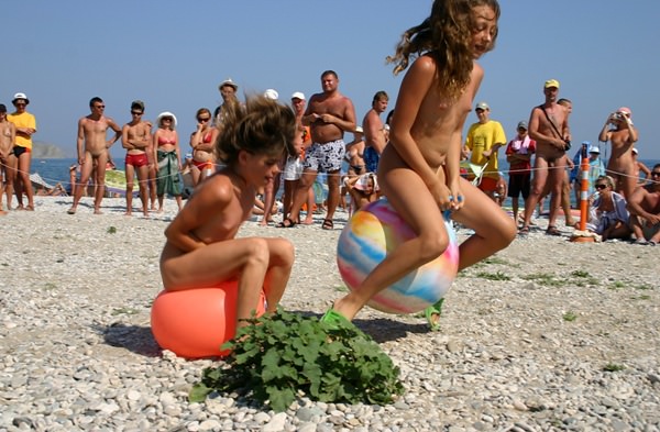 Family nudism - competition of young girls of nudists on jumps on a ball [WorldNudism]